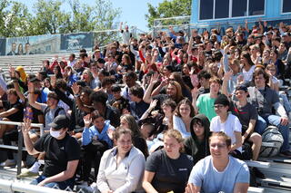 student in the bleachers during the event