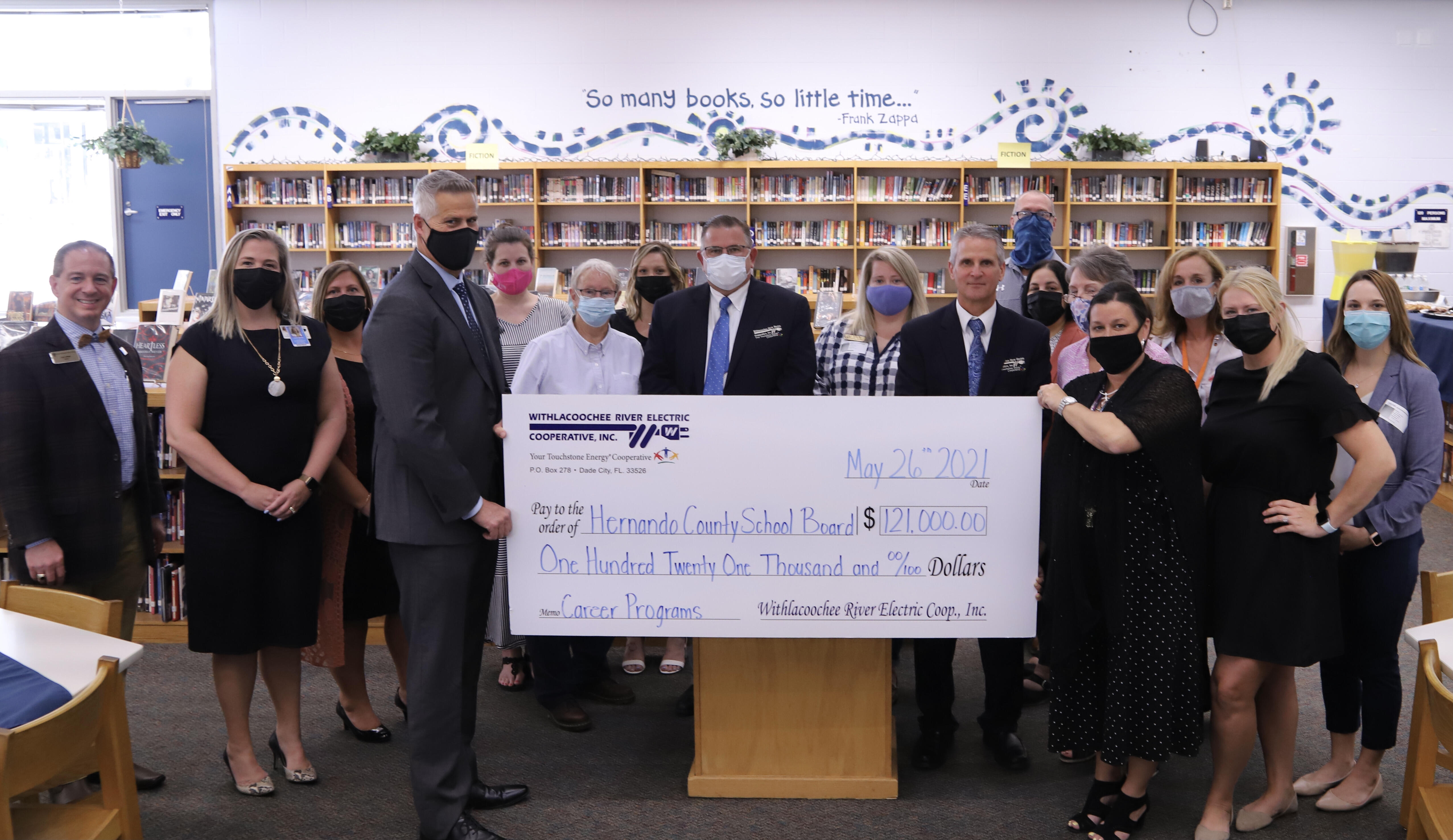 Photo of group holding WREC check for $121,000