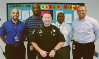 School Resource Officer, Deputy Timothy, with principal and staff
