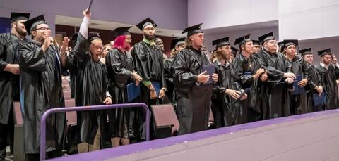 Students moving tassels at graduation