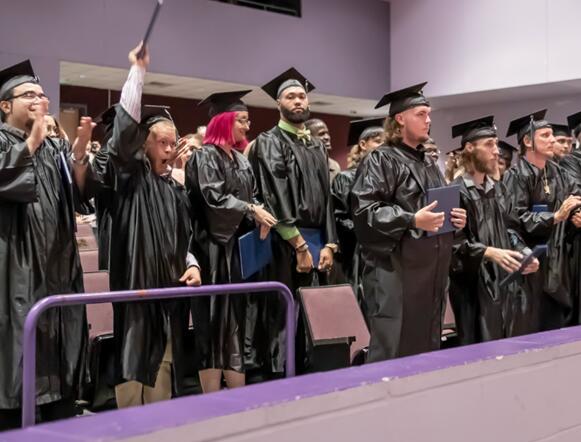 Adult Ed graduates in their cap and gowns